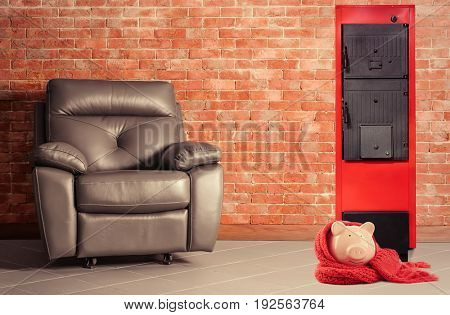 Energy savings concept. Solid fuel boiler and piggy bank with armchair on brick wall background