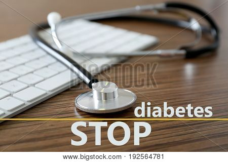 Health care concept. Text STOP DIABETES with stethoscope and keyboard on wooden background