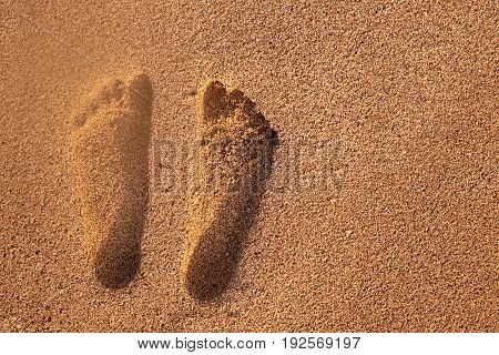 Two well-shaped human footprints in the sand