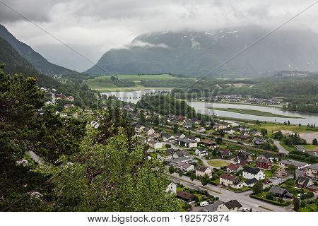 View of Andalsnes city in Norway with mountains on background under a cloudy sky