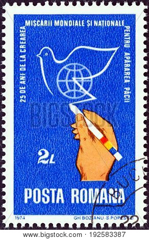 ROMANIA - CIRCA 1974: A stamp printed in Romania issued for the 25th anniversary of World Peace Movement shows hand drawing peace dove, circa 1974.