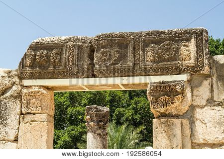 Archaeological site Capernaum, ancient ruins of synagogue of white calcareous stone, on the shore of the Sea of Galilee in Israel