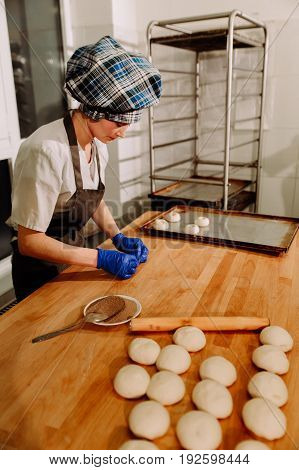Making cinnamon buns. Homemade raw yeast dough after raising ready to bake, a Baker making cinnamon rolls