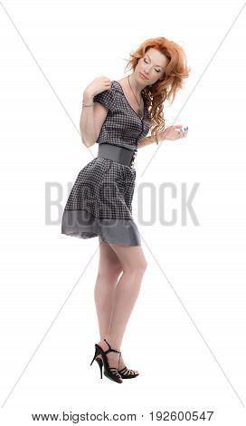 Fulllength shot of a redhead in a grey dress