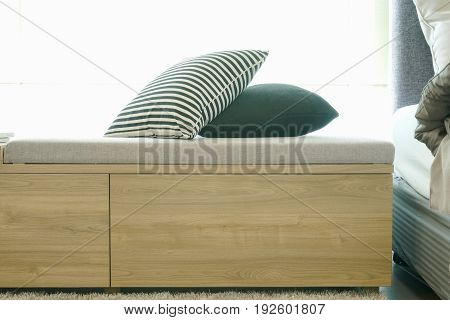 Wooden Daybed With Pillows Next To Bed