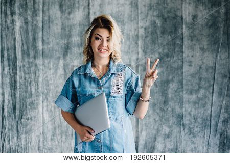 Lovely pretty girl with a laptop smiling and happy that she did the work on time