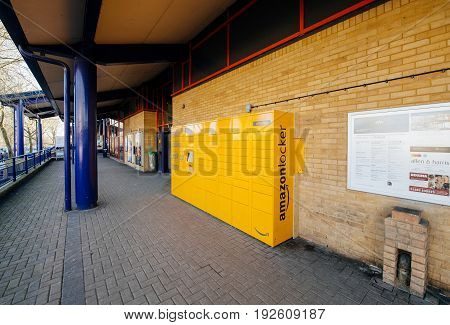 OXFORD UNITED KINGDOM - MAR 2 2017: Perspective view of Amazon locker orange delivery package locker in public place at the train station in Oxford - Amazon Locker is a self-service parcel delivery service offered by online retailer Amazon.com.