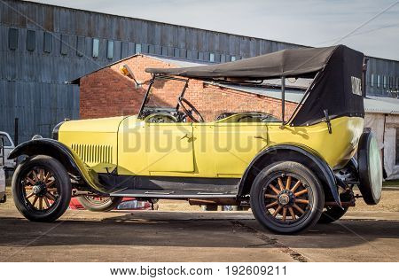 QUEENSTOWN SOUTH AFRICA - 17 June 2017: Vintage Yellow Studebaker Commander car with wooden wheels parked at show