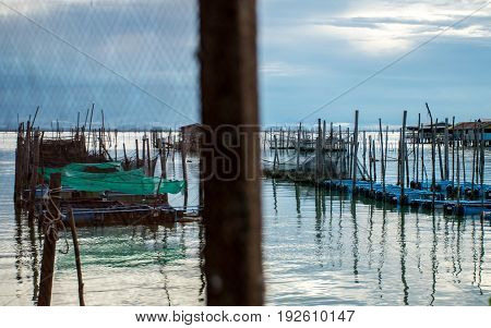 Homestay and floating basket in lake at Kohyo Songkhla Thailand with beautiful sky and clouds. This is traditional fisheries area.