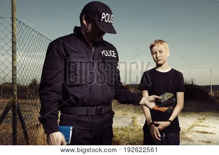 Police man catching youth pickpocket outdoor with three wallets