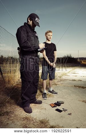 Police man catching youth pickpocket outdoor with three wallets