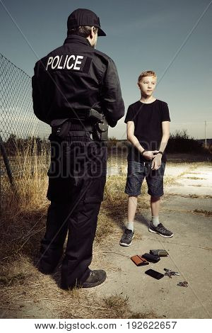 Police man catching youth pickpocket outdoor with three wallets