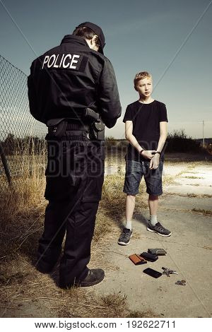 Police man catching youth pickpocket outdoor with three wallets