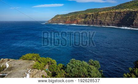 Wide angle view of viewpoint over volcanic coast with high cliffs in Terceira, Portugal