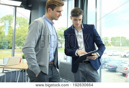 Two businessman dicussing business in the office