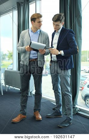 Two businessman dicussing business in the office
