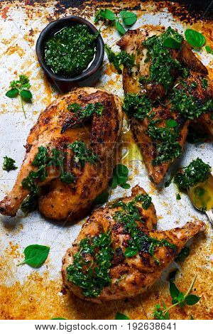 Chicken a grill with chimichury sauce..style rustic.selective focus