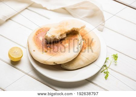 Kulcha is a type of leavened bread originated from the Indian Subcontinent; eaten in India and Pakistan, made from maida. Selective focus. Isolated