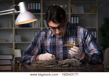 Archeologist working late night in office