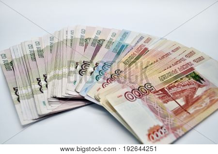 a lot of 5000 1000 1000 banknotes of Bank of Russia on white background Russian rubles spine 100 banknotes of five thousand rubles