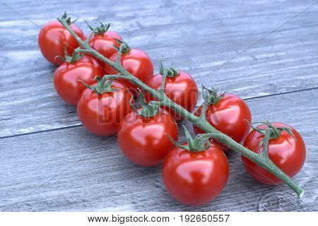 Fresh cherry tomatoes on a wooden background.