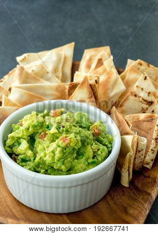 Guacamole vertical view. Guacamole is a avocado based dip traditionally a mexican (Aztecs) dish. Healthy and easy to make at home with a few simple ingredients. Excellent as party food or at bars..