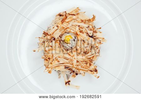 Salad in the form of a nest and decorated with quail eggs.