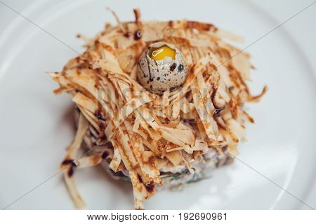 Salad in the form of a nest and decorated with quail eggs.