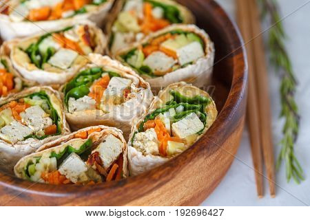 Healthy vegan tofu tortilla wraps with tofu and vegetables top view. Love for a healthy raw food concept.