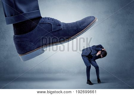 Big foot trying to crush small man who is afraid of that
