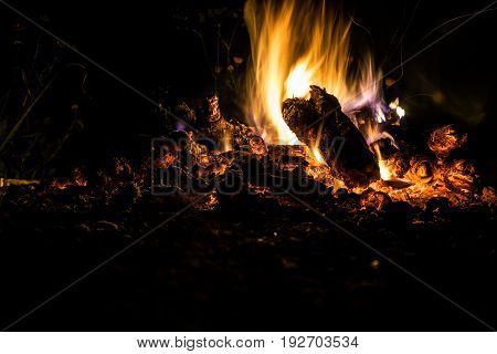 Night fire under the open sky. Outdoors. Languages of flame.