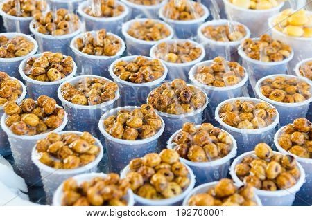 delicious tiger nuts in plastic glasses watered with water.