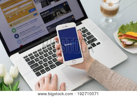 Alushta Russia - May 26 2017: iPhone with app Booking.com online hotel reservations on the screen. iPhone was created and developed by the Apple inc.