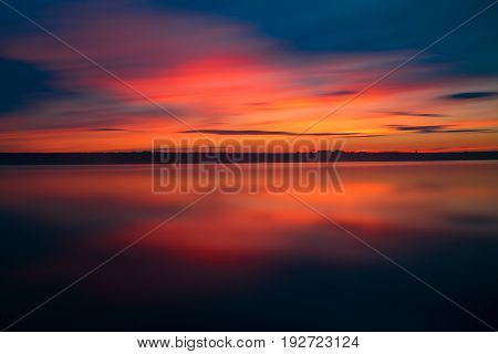 Orange And Red Sunset At Coast Of The Lake