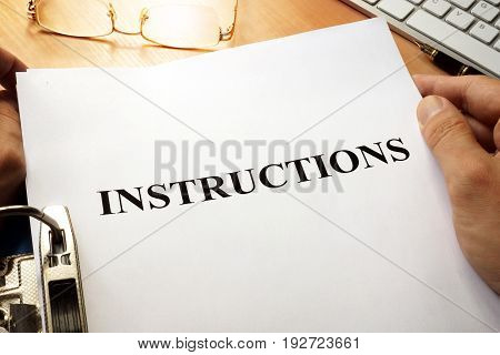 Instructions in a blue folder. Guidebook concept.
