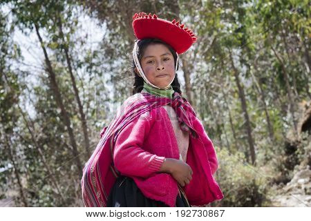 Peruvian girl dressed in colourful traditional handmade outfit. October 21 2012 - Patachancha, Cuzco, Peru