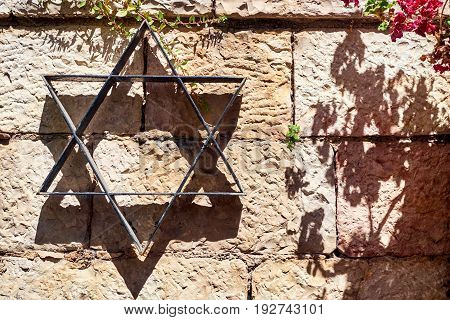 Star of David on the stone wall background