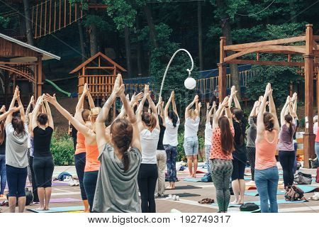 VORONEZH, RUSSIA - JUNE 18, 2017: A lot of people are engaged in yoga in the Dynamo park on the International Yoga Day in Voronezh, Russia