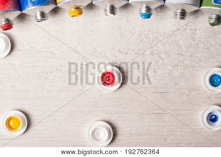 Tubes Of Paint On A Wooden Background,