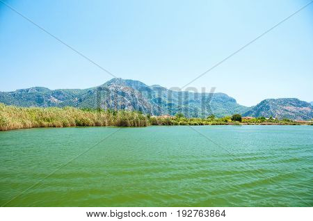 TURKEY, MUGLA , DALYAN. The Dalyan River with tourist boat in the straits of the river