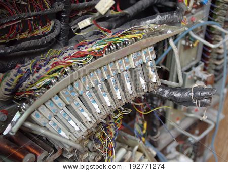 Electric elements and connection of old telecommunication machine. Part of retro telephone exchange.