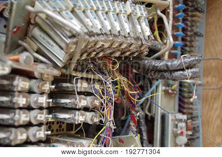 Electric elements and connection of old telecommunication machine. Part of retro telephone exchange.
