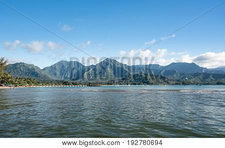 Afternoon from boat trip at Hanalei Bay and pier with the Na Pali coast in the background near Hanalei, Kauai, Hawaii