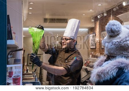Brussels Belgium - February 24 2017: A chocolatier makes chocolate in Neuhaus a notable Belgian chocolatier which manufactures and sells luxury chocolates biscuits and ice cream.
