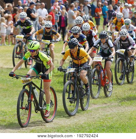 STOCKHOLM SWEDEN - JUNE 11 2017: Large group of fighting mountain bike cyclists i cycling uphill at Lida Loop Mountain bike Race audience in background. June 11 2017 in Stockholm Sweden