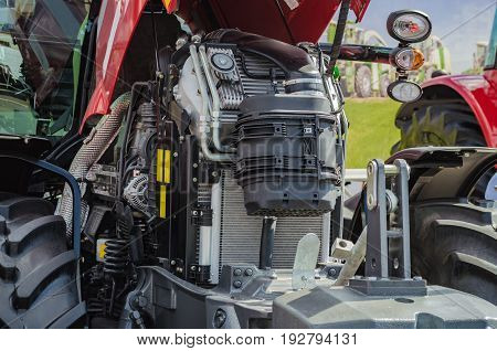 Powerful high-tech tractor engine in modern design, mounted on a frame with an open hood