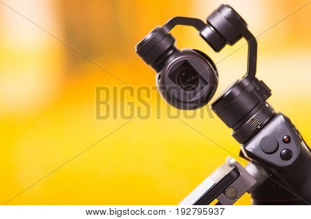 QUITO, ECUADOR- DECEMBER 22, 2017: Osmo Mobile gimbal, new generation of electronic stabilizer in a blurred forest background.