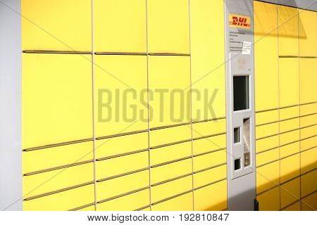 MAINZ, GERMANY - MAY 27: Lockers or stacked and juxtaposed parcel boxes with a customer ticket machine of the DHL on May 27, 2017 in Mainz.