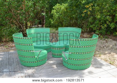Comfortable green wicker chairs and table in a restaurant