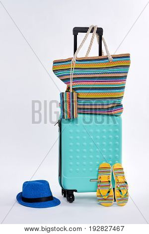 Beach accessories and wheeled suitcase. Trip for seaside.